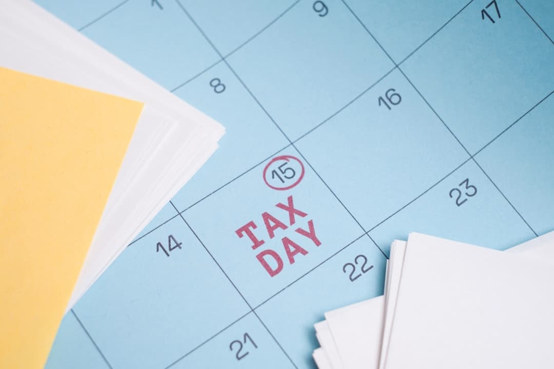 Business owner reviewing tax documents and calendar at organized desk