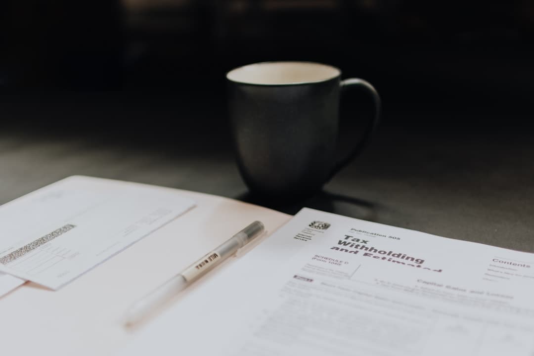 Small business owner reviewing tax forms and contractor payment records at a desk