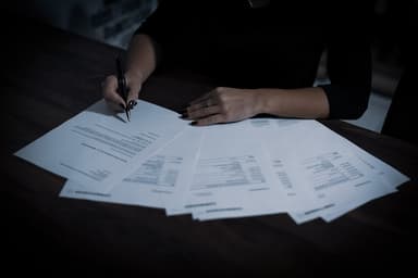 Small business owner reviewing IRS notice documents at a desk with a calculator and folders