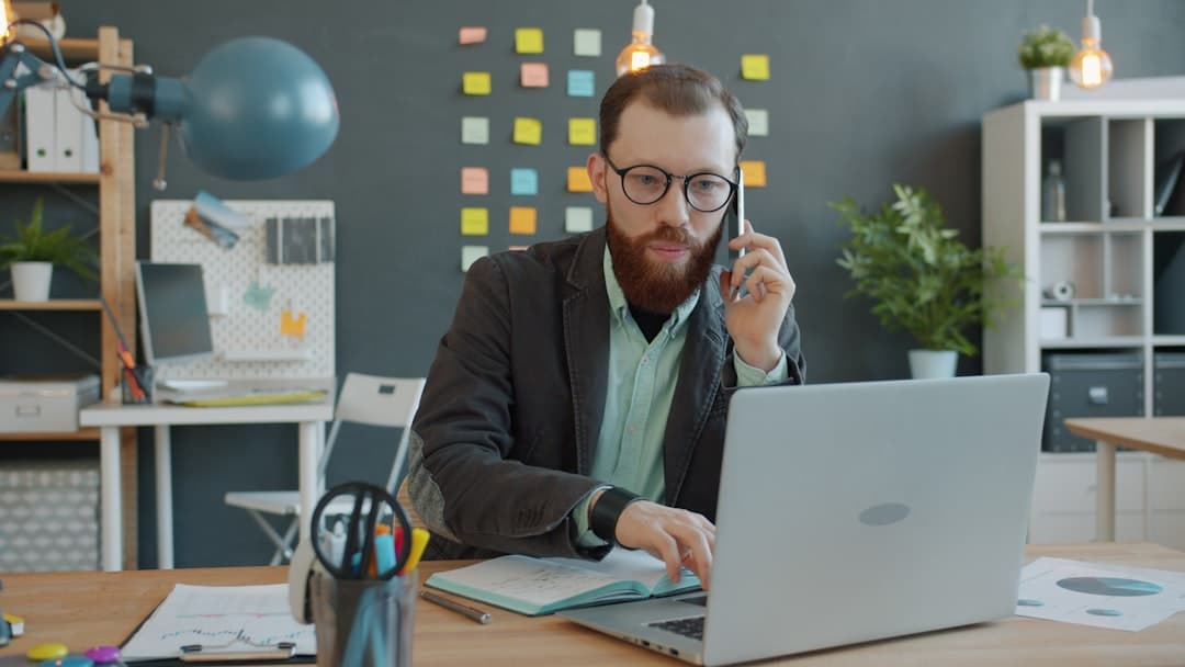 Small business owner reviewing worker classification documents at desk