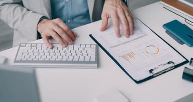 Business professional reviewing contractor paperwork with missing information highlighted