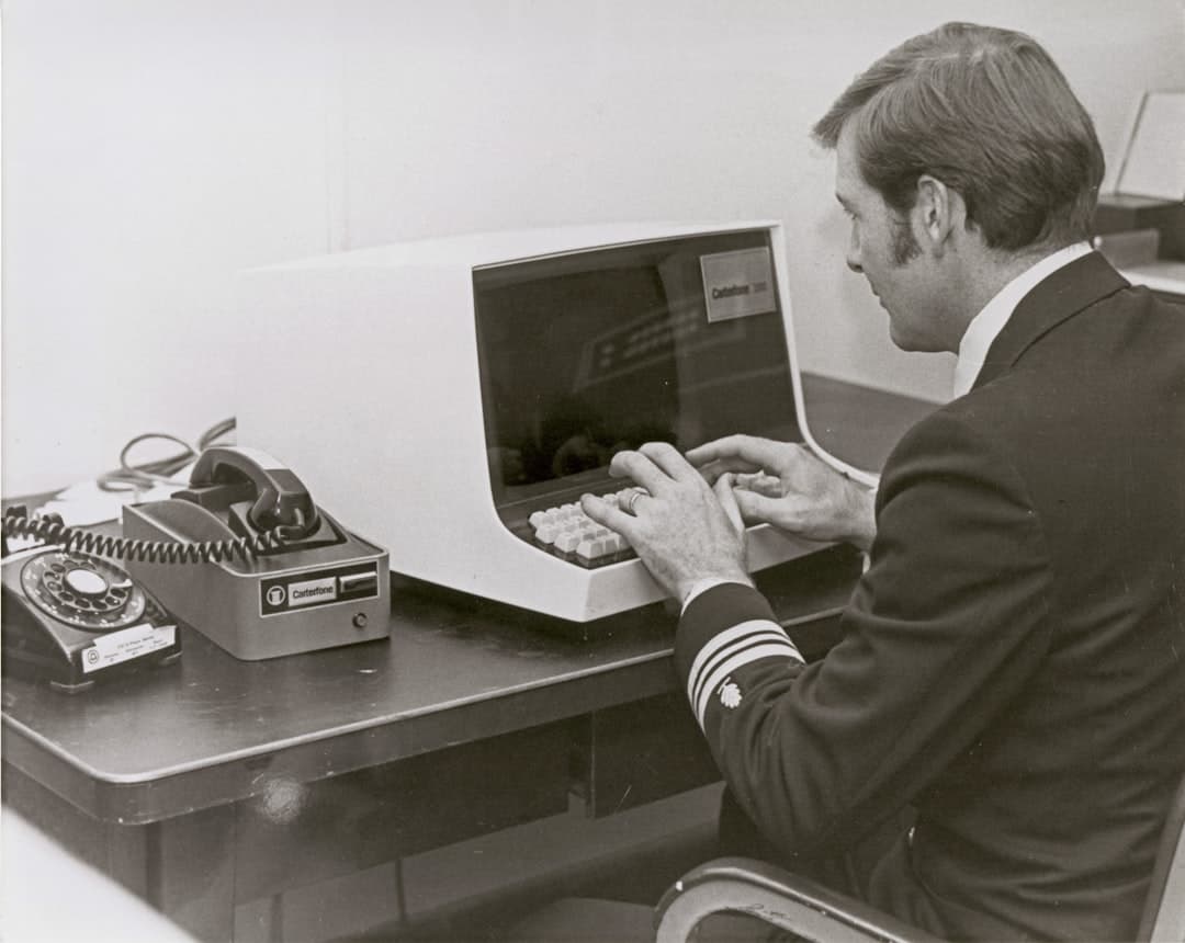 Business professional reviewing tax documents and forms at desk with computer