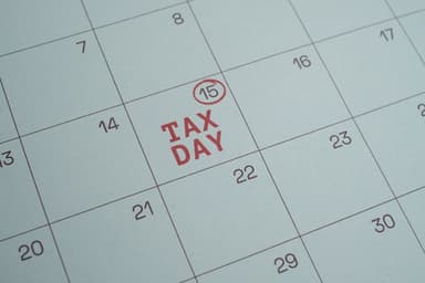 Business calendar and tax documents on desk showing planning timeline