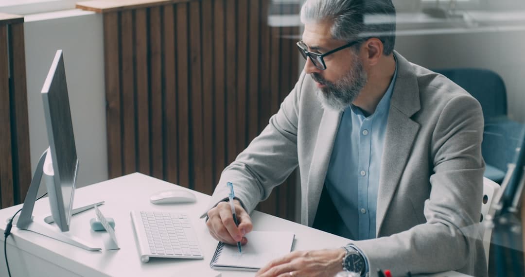 Business professional reviewing and correcting tax documents at desk