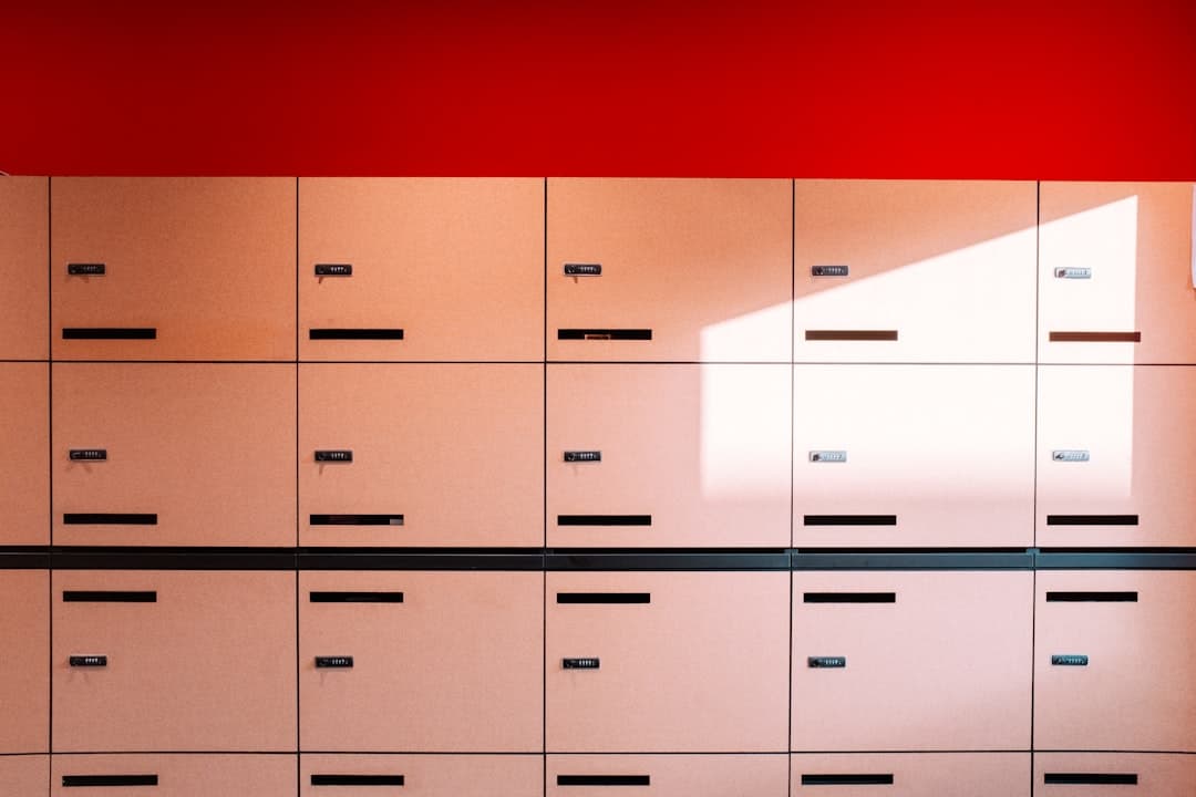 Business professional working at desk with locked filing cabinet and security documents