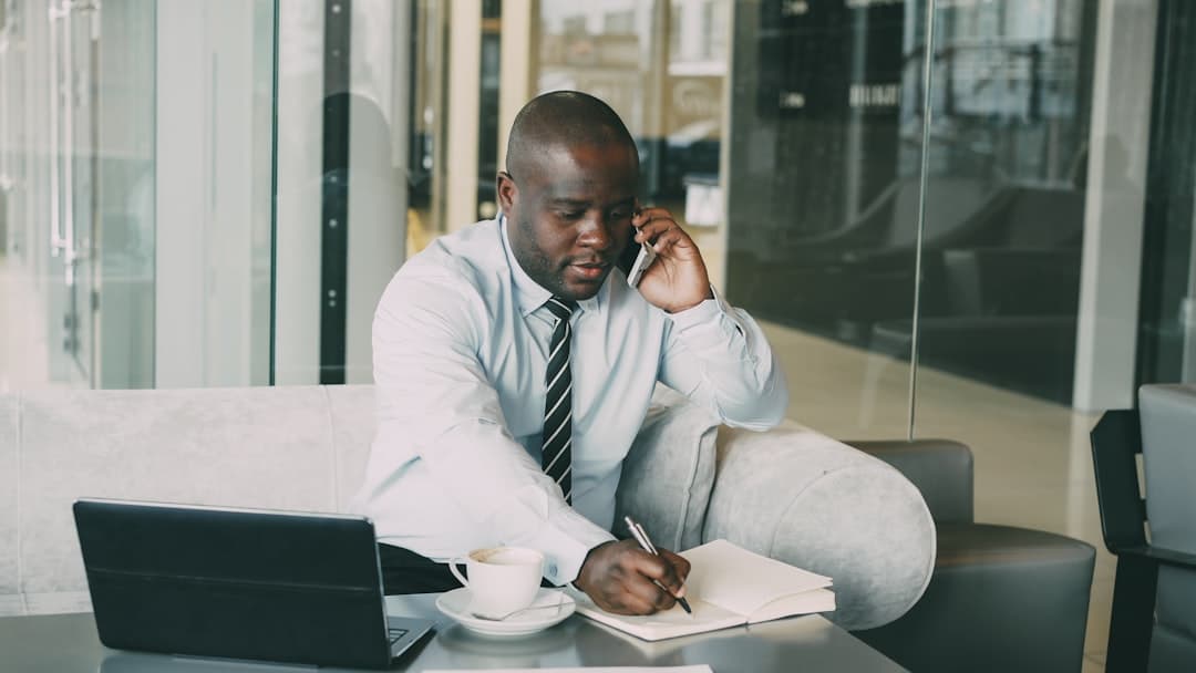 Small business owner reviewing tax documents and paperwork at desk with calculator and calendar